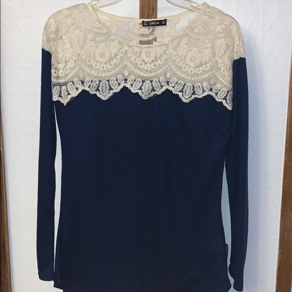A BLUE LONG SLEEVE, with white lace on the top